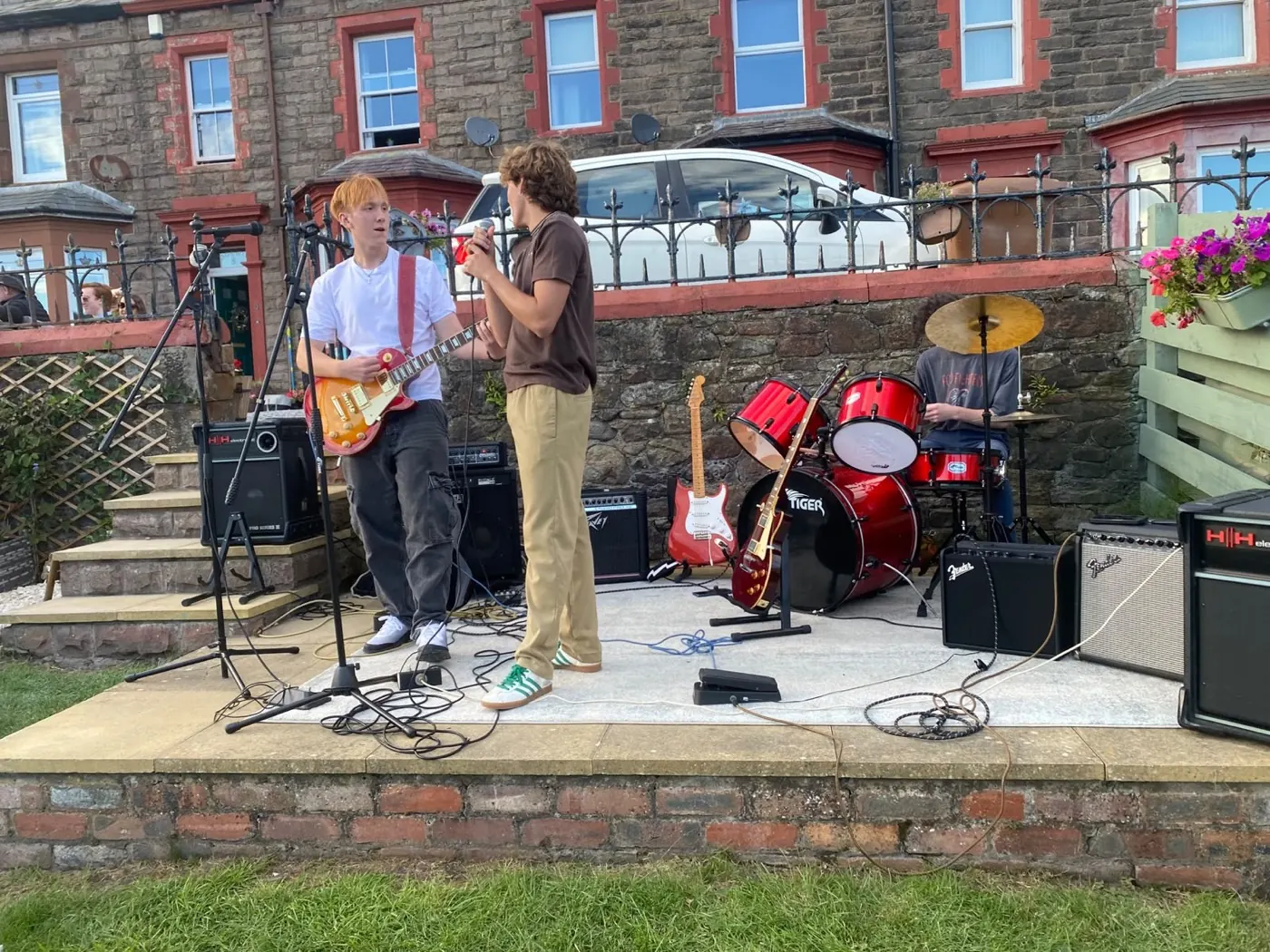 Playing outdoors on a stone terrace in front of a red sandstone terrace house