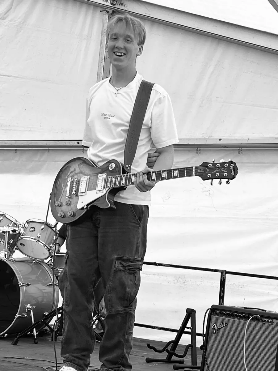 Guitarist with a Les Paul on a marquee stage, black and white